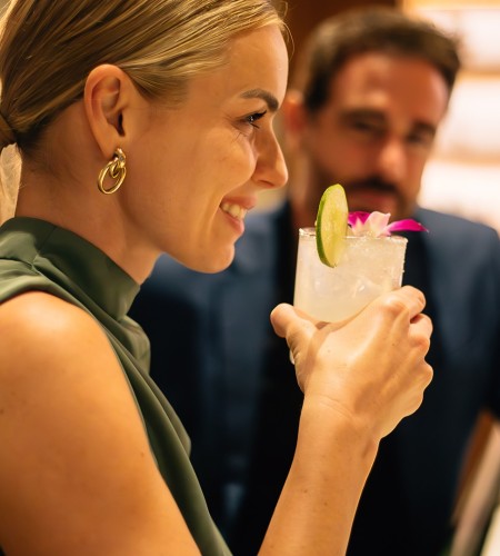 a woman holding a drink