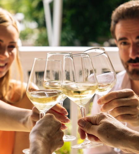 a group of people clinking wine glasses