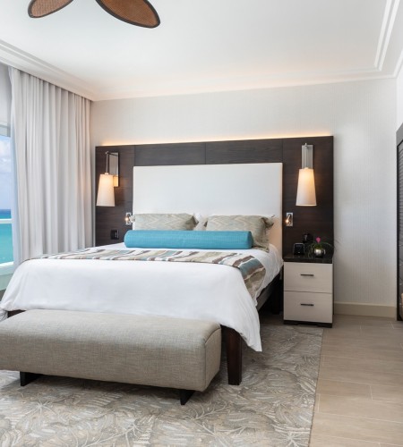 a bedroom with a large bed and a large window