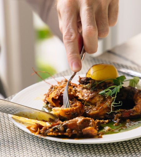 a person eating food on a plate