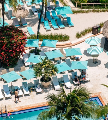 a pool with umbrellas and lounge chairs