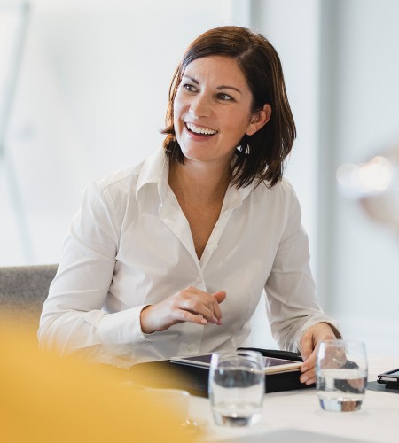 a woman smiling at a table