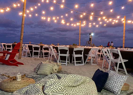 a group of tables and chairs on a beach