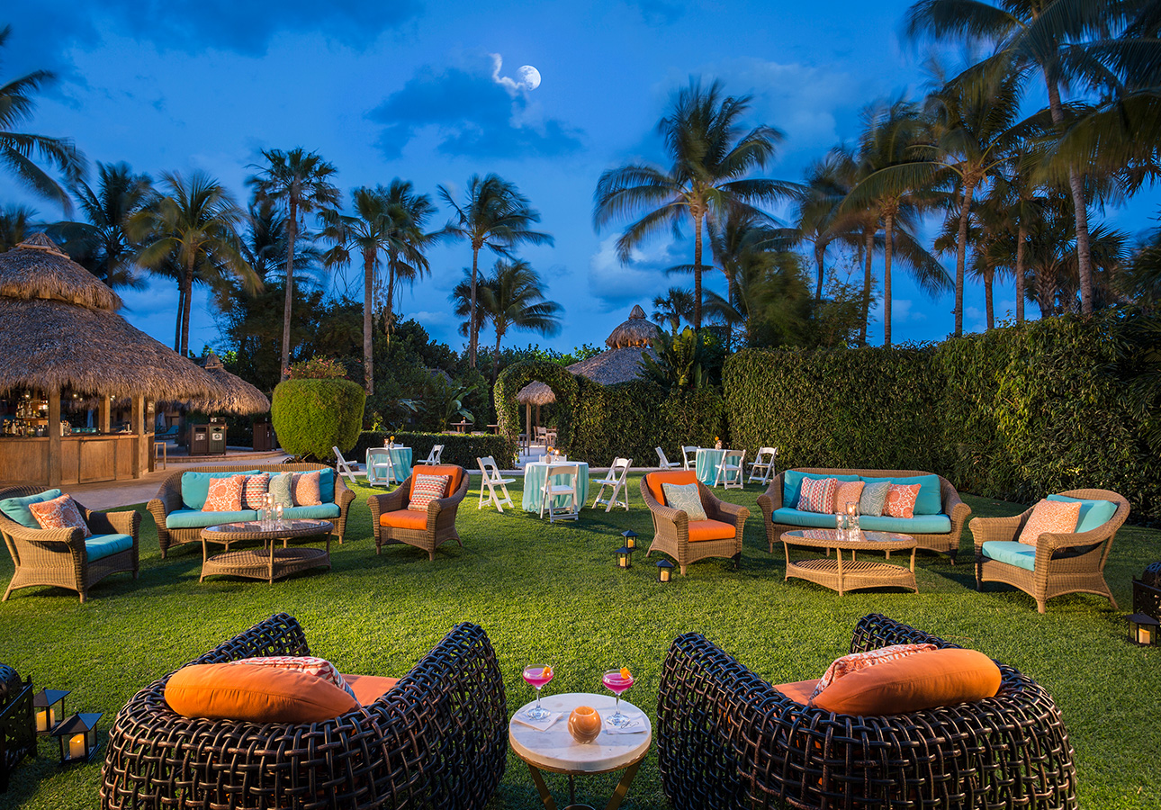 a group of chairs and tables on a grass lawn