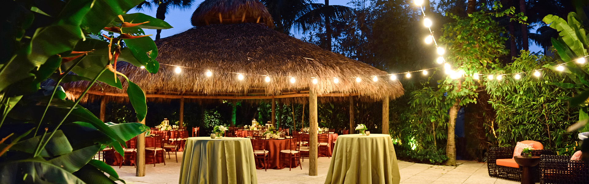 a hut with tables and chairs