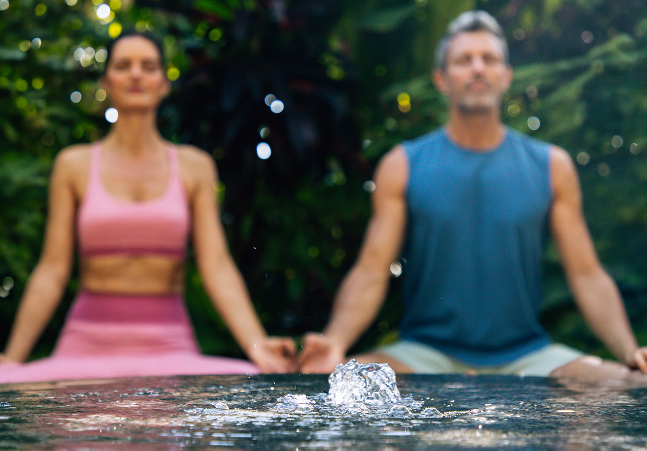 a man and woman meditating in the air