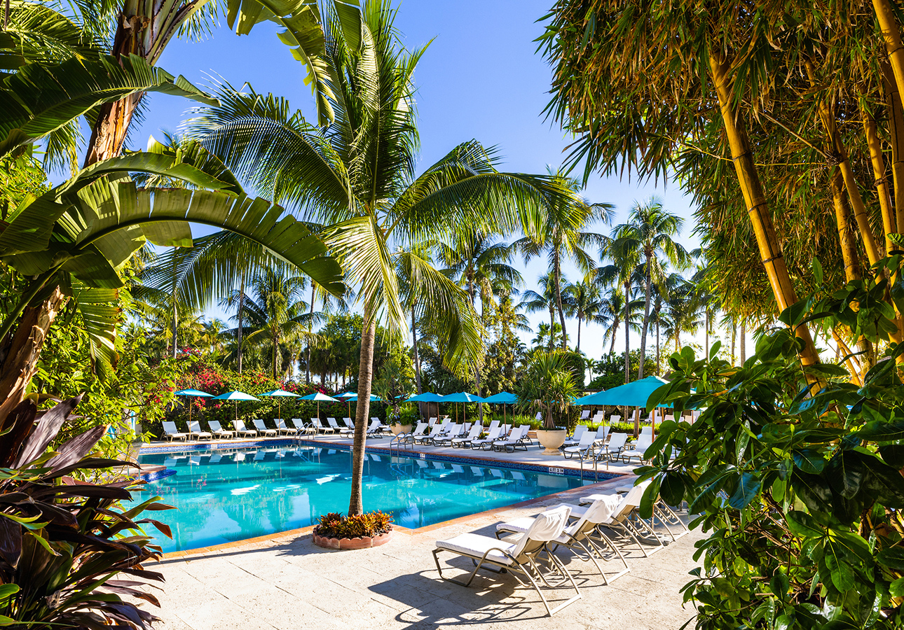 a pool with chairs and umbrellas