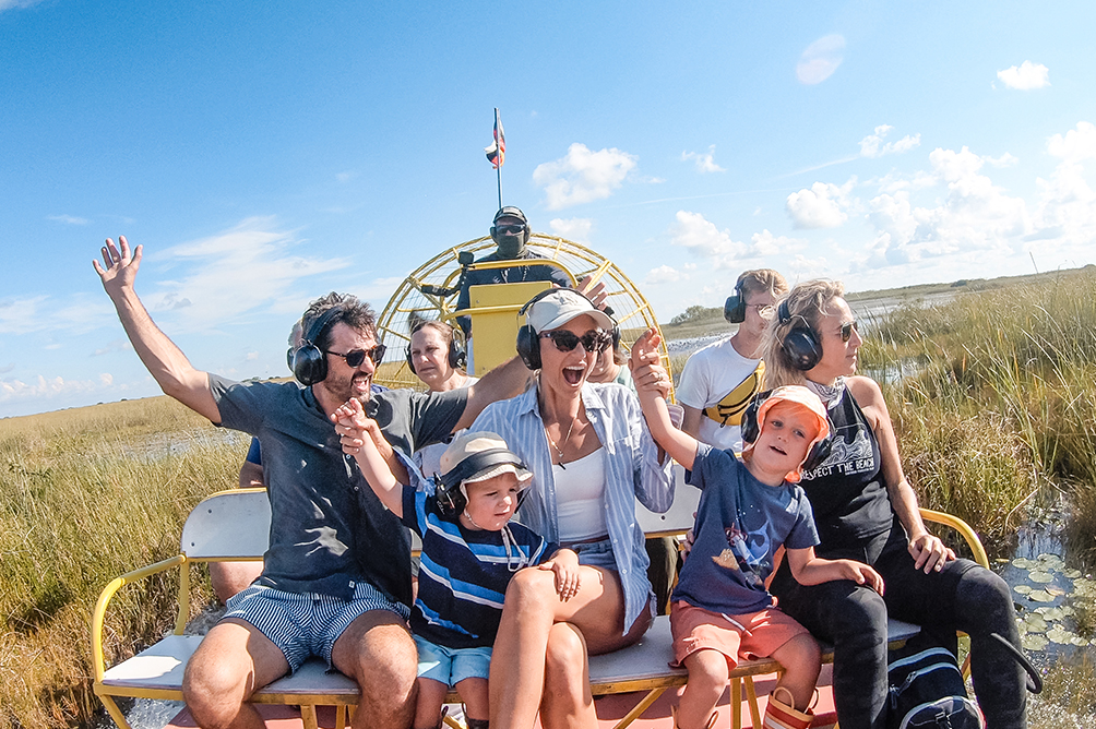a group of people sitting on a bench with headphones on
