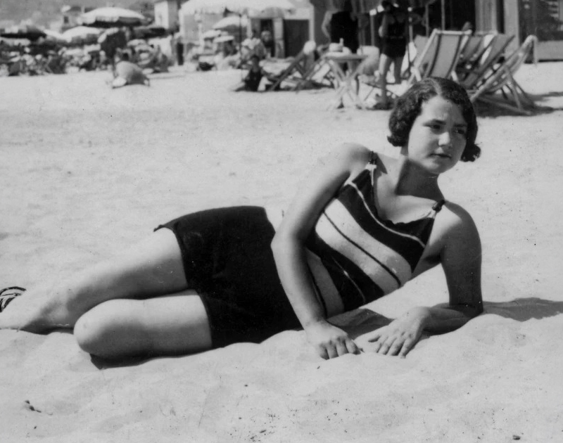 a woman lying on the sand