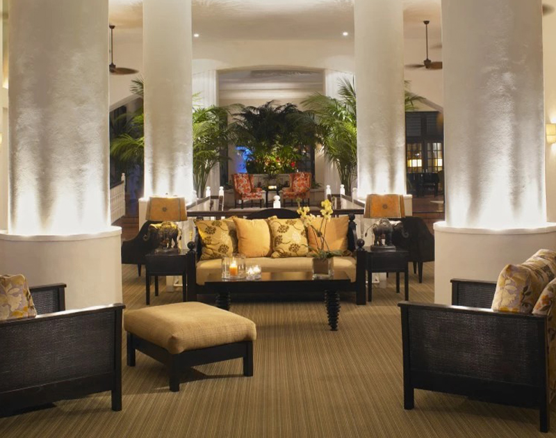 a room with a couch and chairs