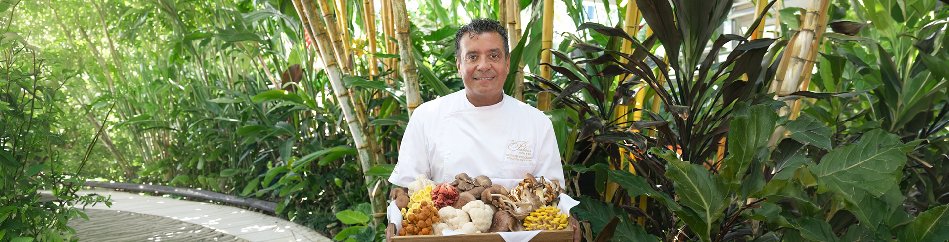 a man holding a box of mushrooms