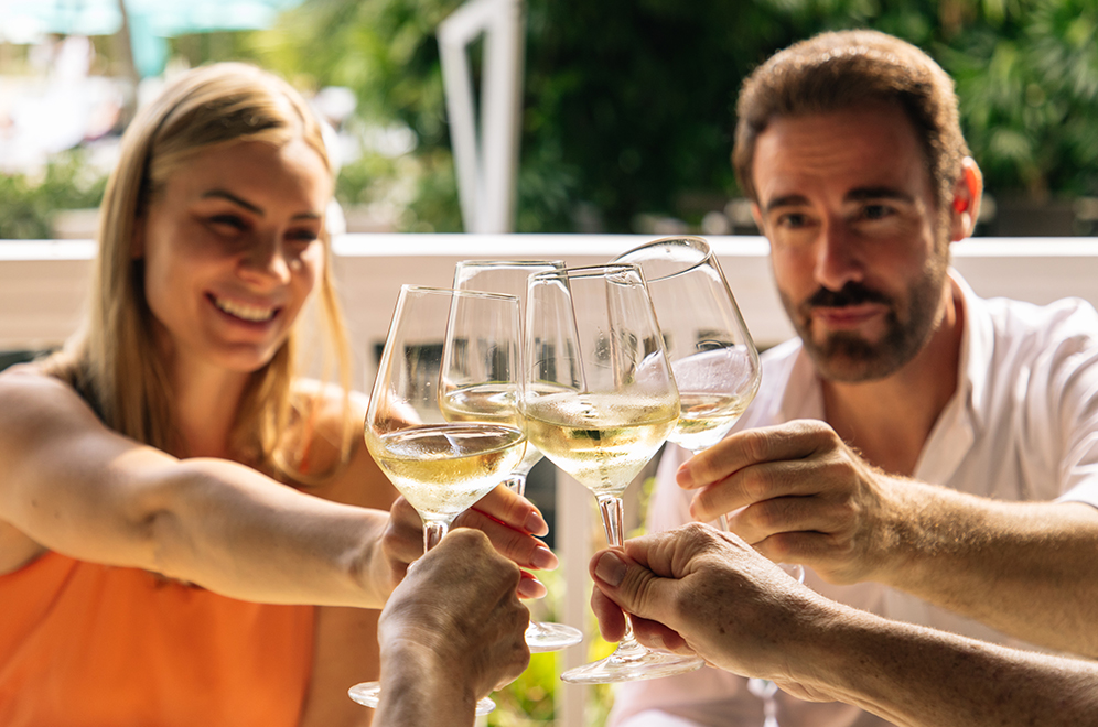 a group of people clinking wine glasses