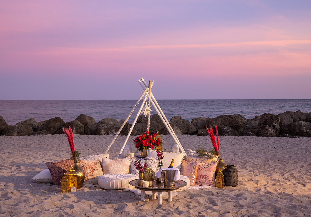 a table and chairs on a beach