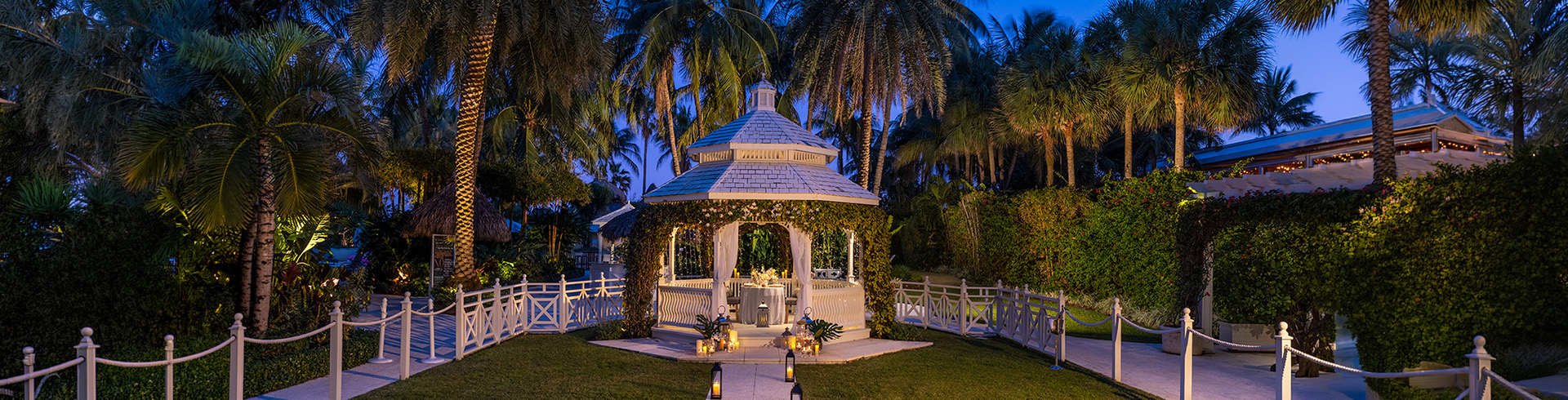 a gazebo with a white gazebo surrounded by trees