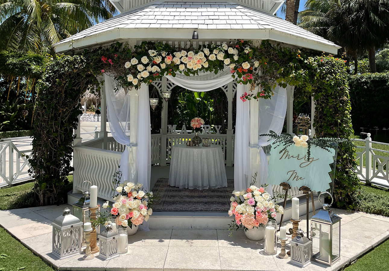 a gazebo with flowers and candles