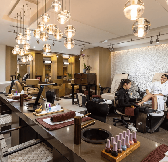 a woman sitting in a chair in a beauty salon