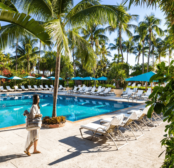 a woman standing near a pool