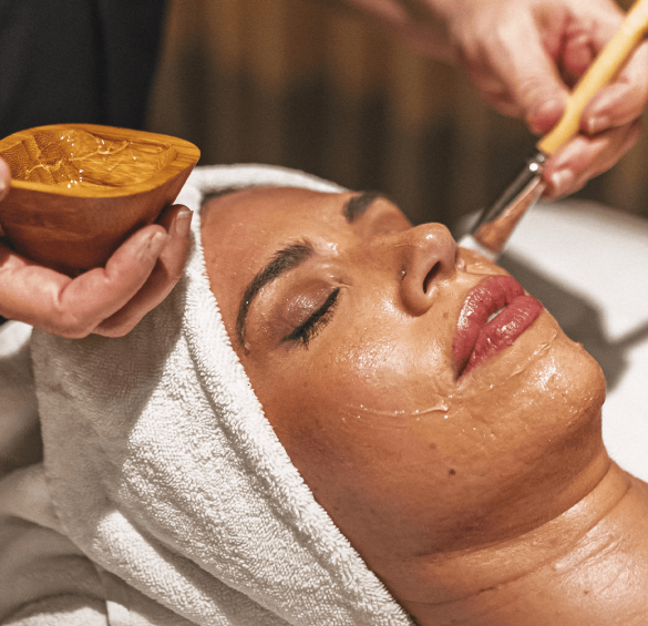 a woman getting a facial mask