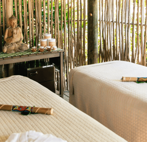 a massage room with a wooden table and a statue