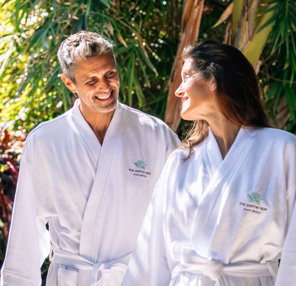a man and woman wearing white robes