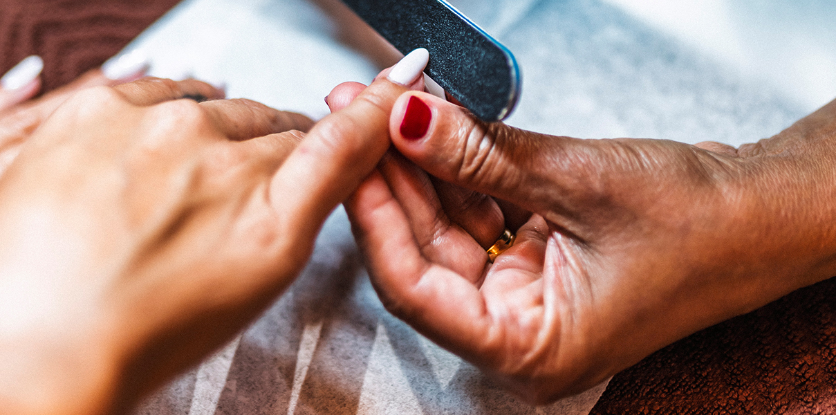 a person receiving a manicure
