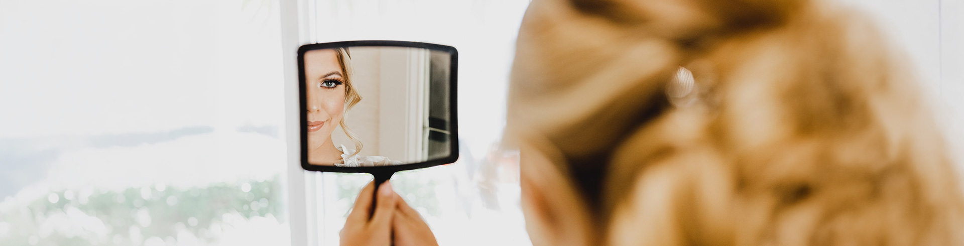 a woman looking at herself in a mirror