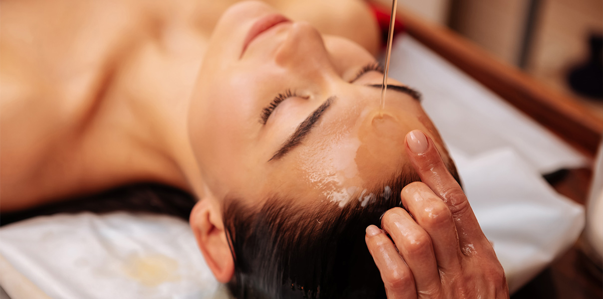 a woman receiving a face massage