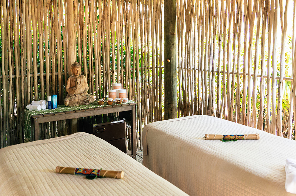 a room with two beds and a statue of a buddha