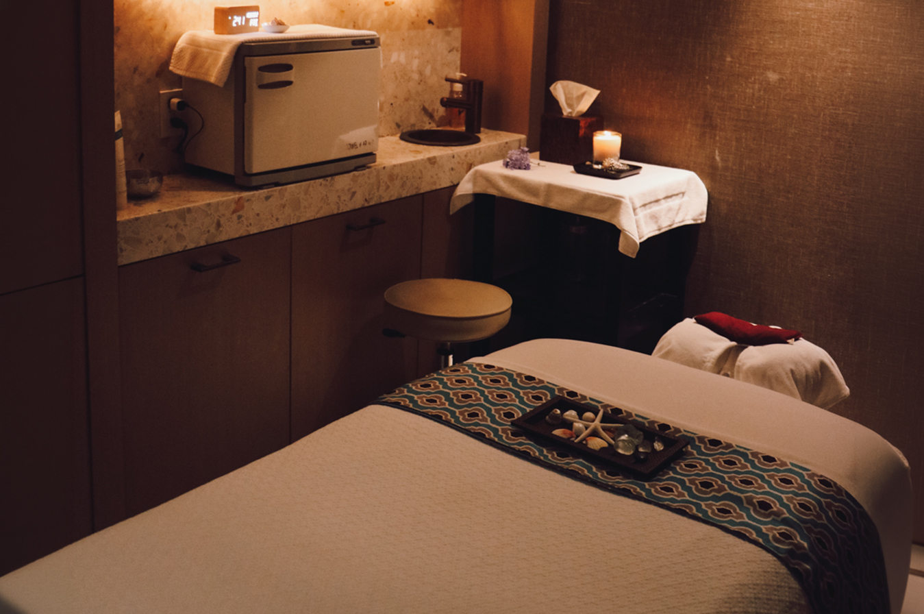 a massage room with a small table and a microwave
