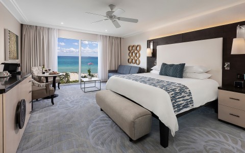 a room with a bed and a table and chairs