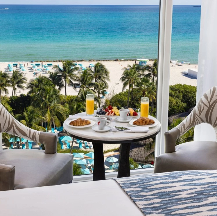 A breakfast table set with a beach view