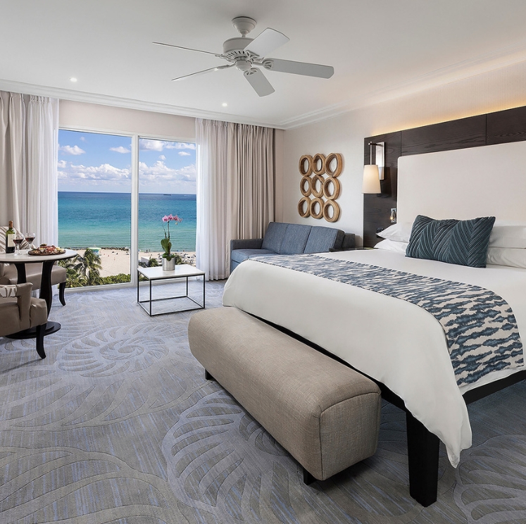 a room with a bed and a table and chairs