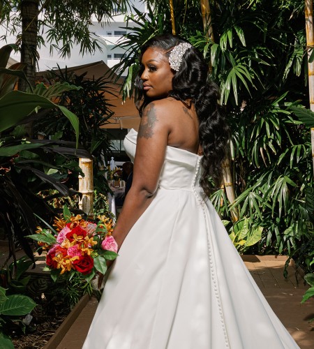 a woman in a white dress holding flowers