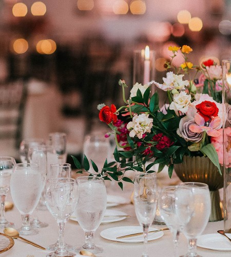 a table set with flowers and candles