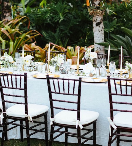 a table with chairs and flowers on it
