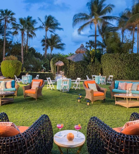 a group of chairs and tables on a lawn