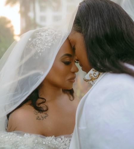 a woman in a wedding dress touching her forehead