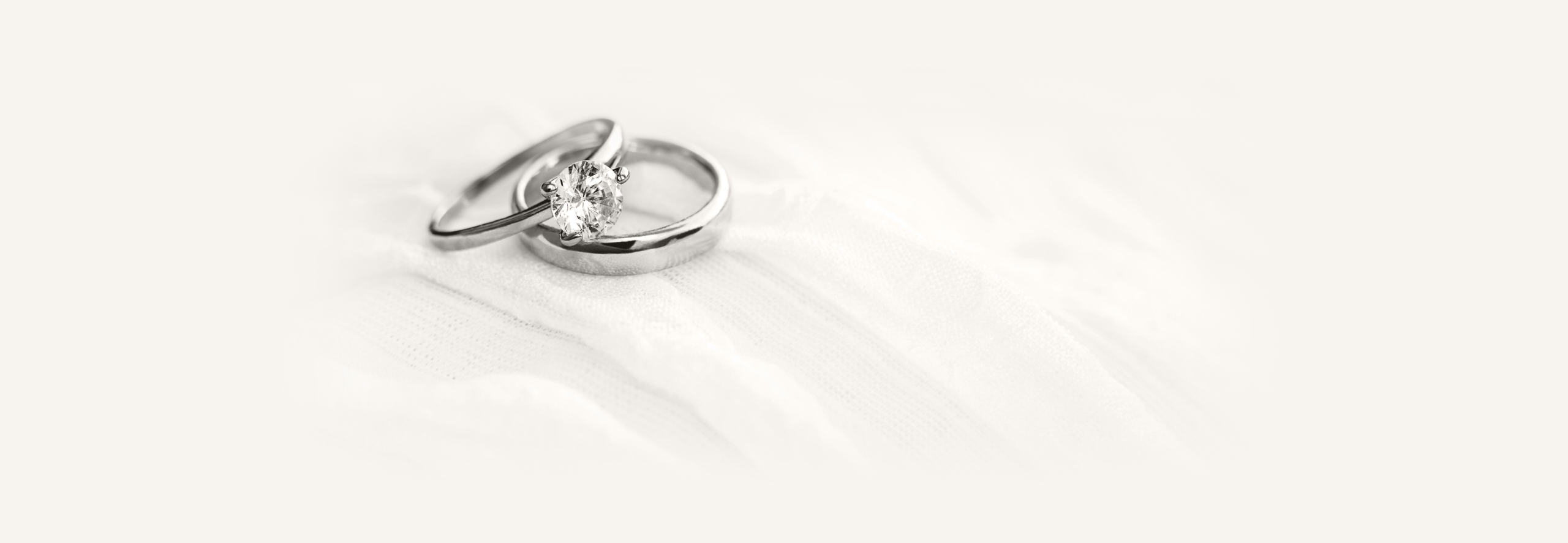 a pair of silver rings with a diamond