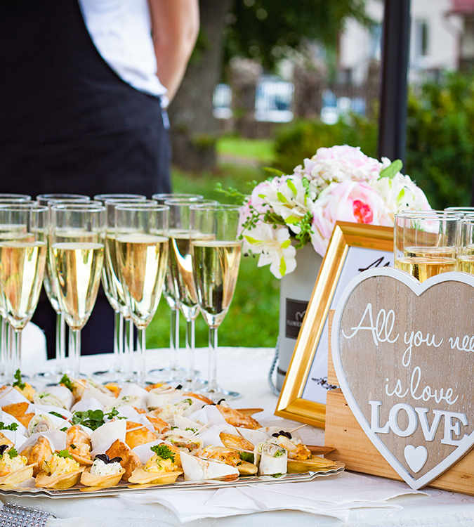 a tray of food and champagne glasses
