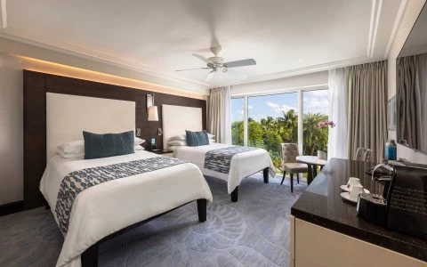 a room with two beds and a desk