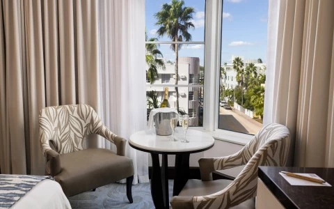 a room with a window and chairs and a table