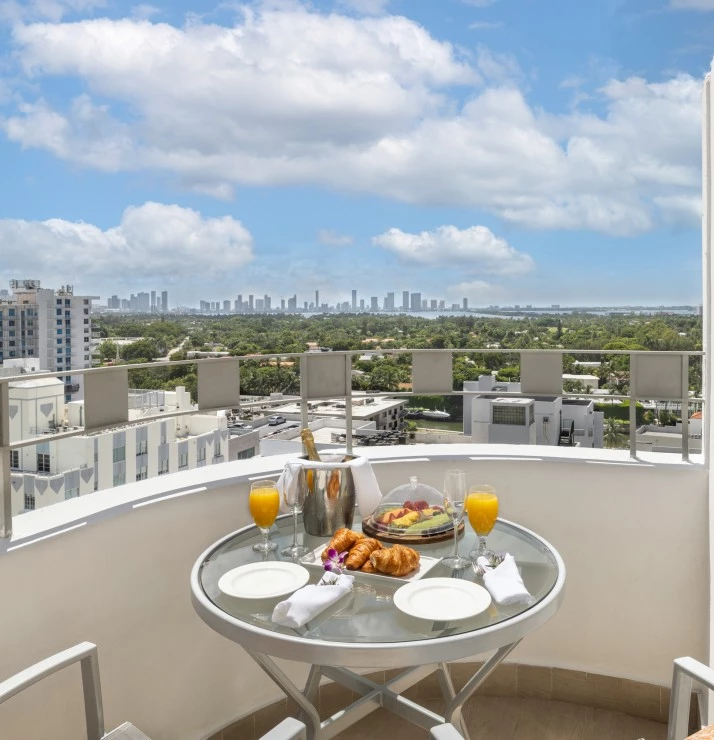 a table with food and drinks on it on a balcony