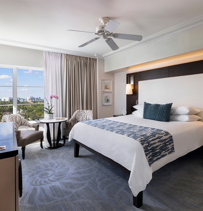 a room with a bed and a table and chairs