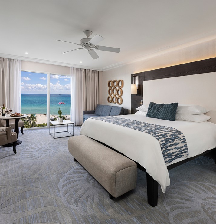 a room with a bed and a table and chairs