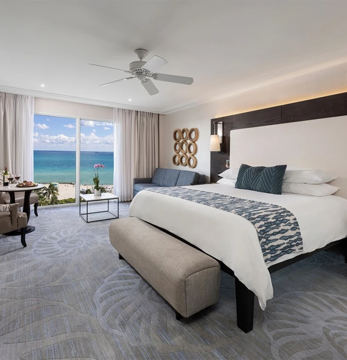 a room with a bed and a table and chairs