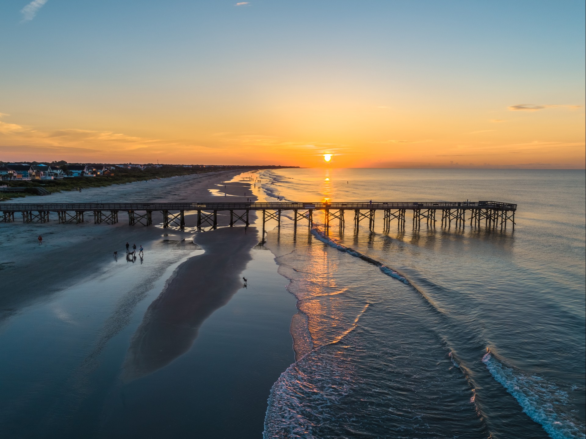 a long wooden bridge over a beach
