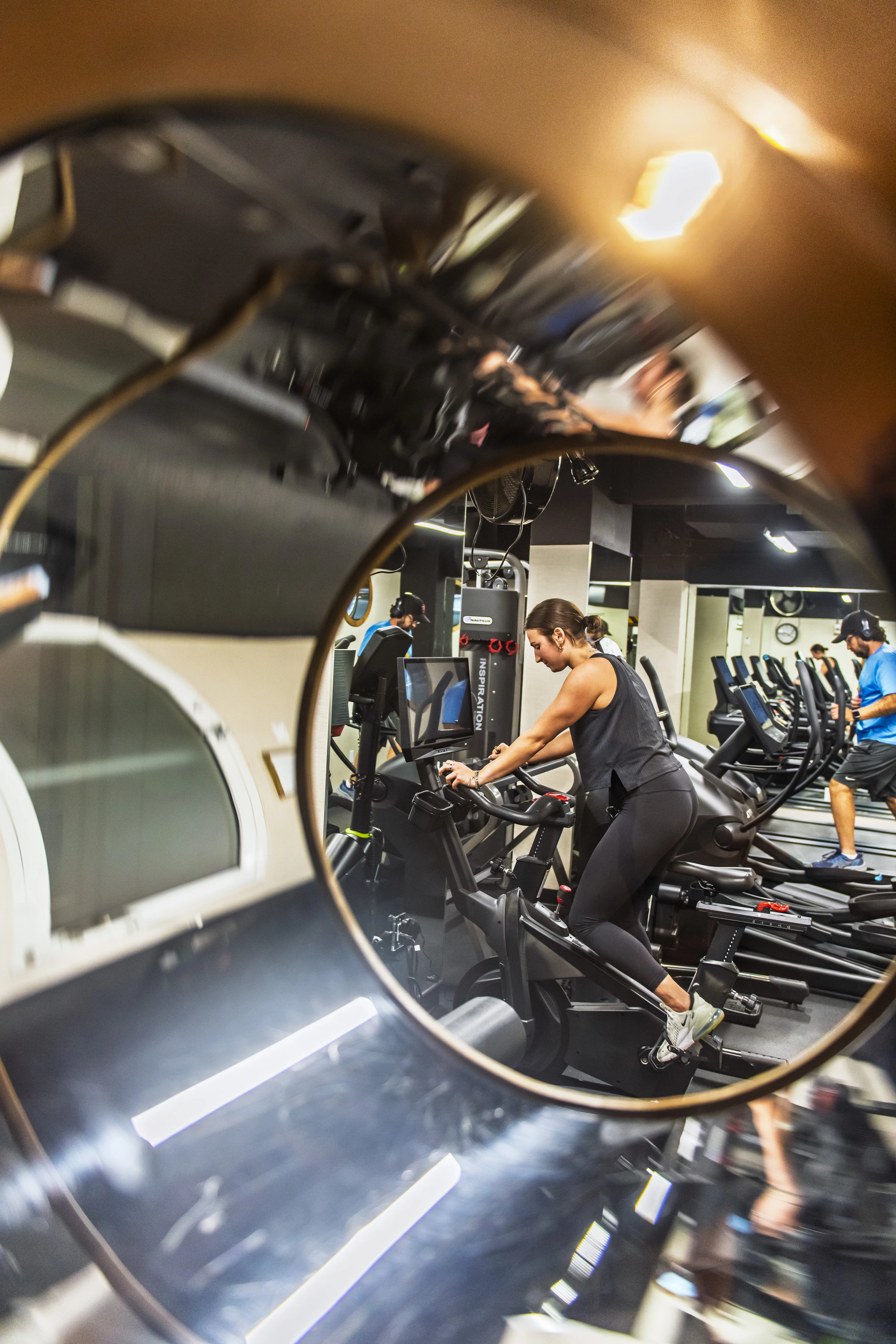 a mirror of a woman on exercise bikes