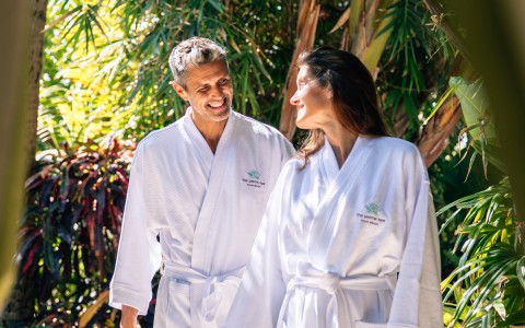 a man and woman wearing white robes
