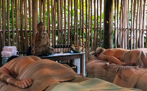 a group of people lying on massage beds