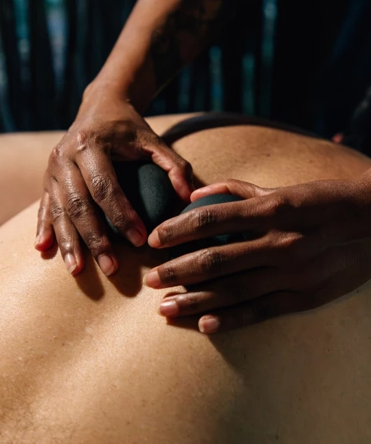 a person's hands on a person's back